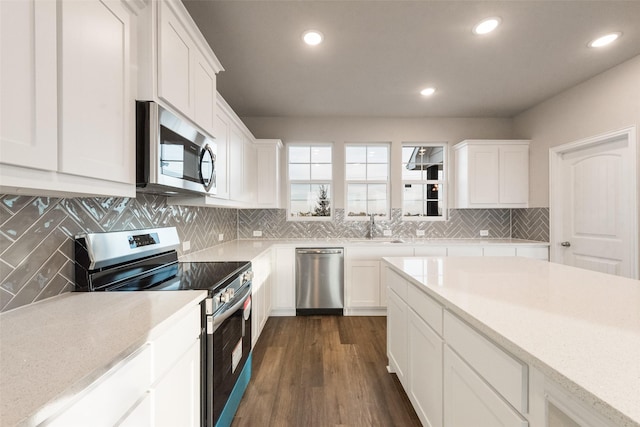 kitchen with dark hardwood / wood-style flooring, sink, white cabinets, and appliances with stainless steel finishes