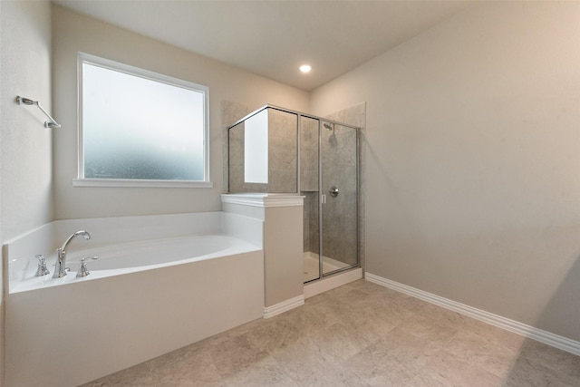 bathroom featuring independent shower and bath