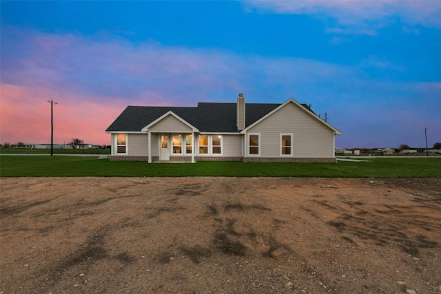 back house at dusk with a yard