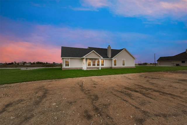 ranch-style home featuring a lawn