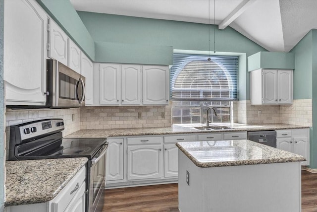 kitchen with white cabinetry, sink, stainless steel appliances, and a center island