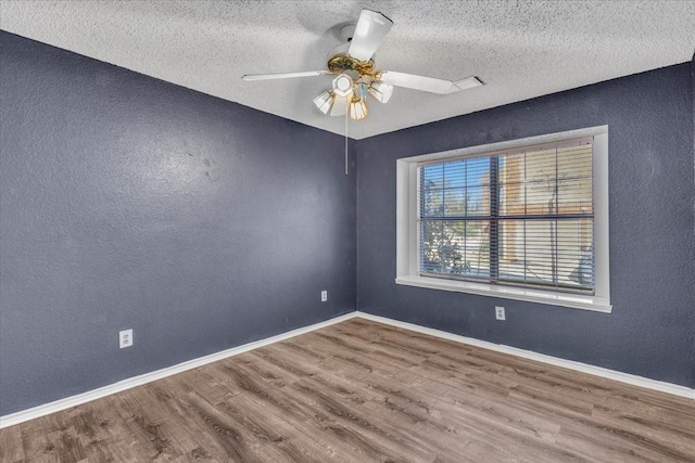 unfurnished room with hardwood / wood-style flooring, a textured ceiling, and ceiling fan