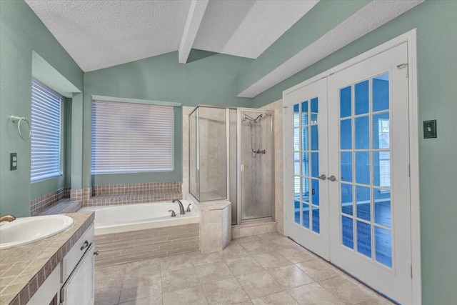 bathroom with vanity, lofted ceiling with beams, a textured ceiling, french doors, and separate shower and tub