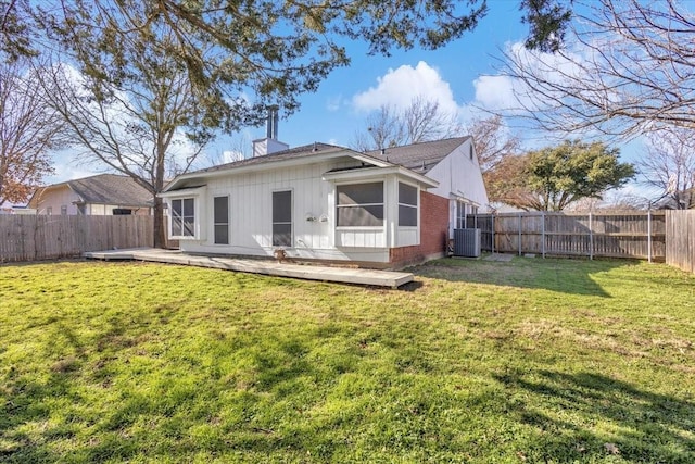 rear view of house featuring central AC, a sunroom, a patio area, and a lawn