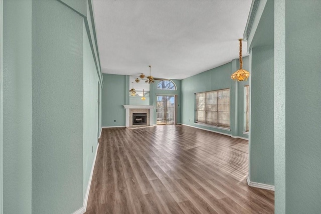 unfurnished living room featuring hardwood / wood-style flooring and ceiling fan