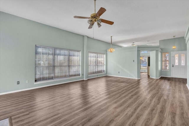 unfurnished living room with ceiling fan, wood-type flooring, and vaulted ceiling