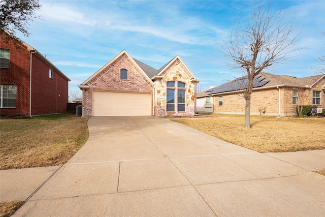 view of front facade with a garage and a front lawn