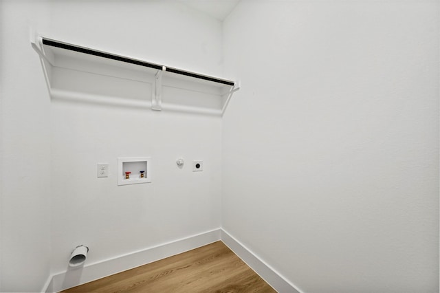 clothes washing area featuring hardwood / wood-style flooring, gas dryer hookup, electric dryer hookup, and hookup for a washing machine