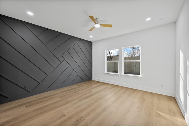 spare room featuring ceiling fan and light wood-type flooring