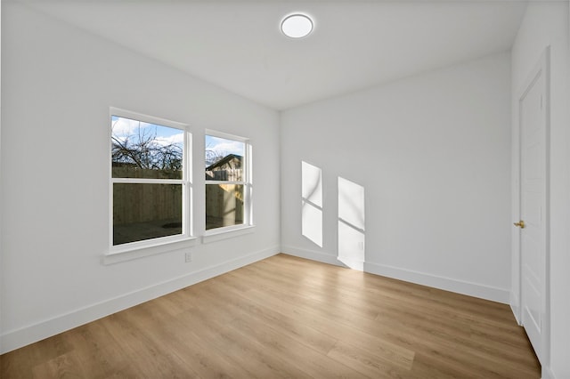 empty room with light hardwood / wood-style flooring