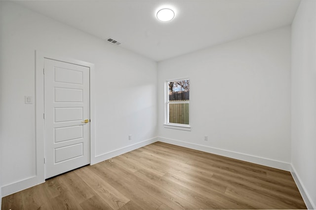 unfurnished room featuring hardwood / wood-style flooring