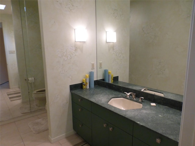 bathroom with vanity, tile patterned floors, and toilet