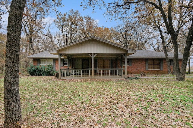 ranch-style home with a porch and a front lawn