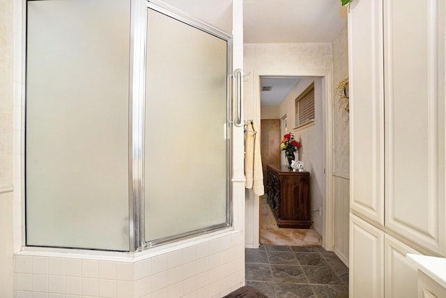 bathroom featuring a shower with shower door