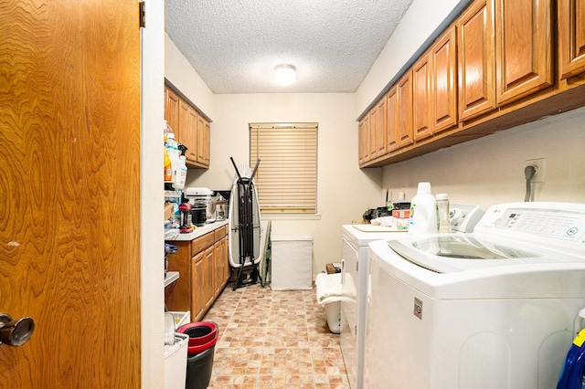 washroom featuring cabinets, separate washer and dryer, and a textured ceiling