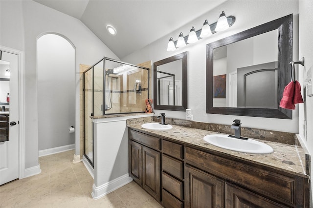 bathroom featuring lofted ceiling, tile patterned flooring, a shower with door, and vanity