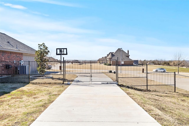 view of gate with a yard