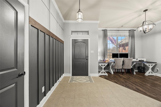 entryway with tile patterned flooring and crown molding