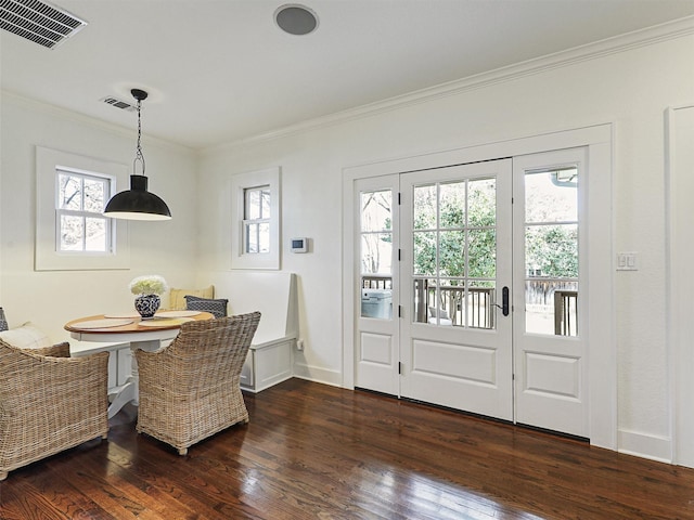 dining room featuring french doors, crown molding, dark wood-type flooring, and breakfast area