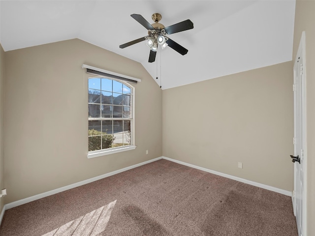 spare room with ceiling fan, carpet flooring, and vaulted ceiling