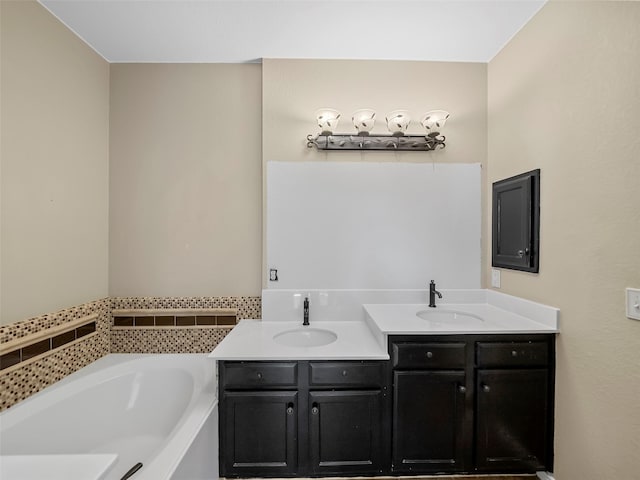 bathroom featuring vanity and a tub to relax in