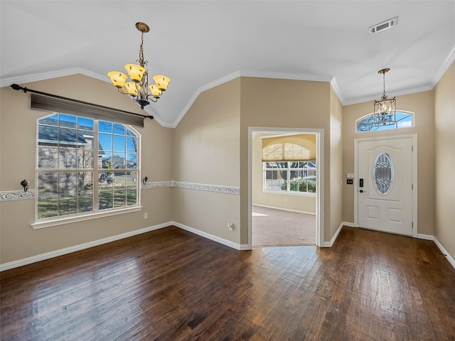 entrance foyer featuring an inviting chandelier, vaulted ceiling, and ornamental molding