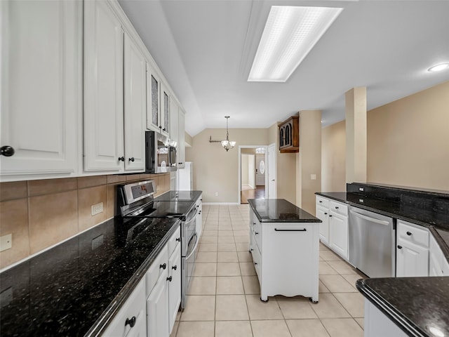 kitchen featuring a kitchen island, appliances with stainless steel finishes, decorative light fixtures, white cabinetry, and light tile patterned floors