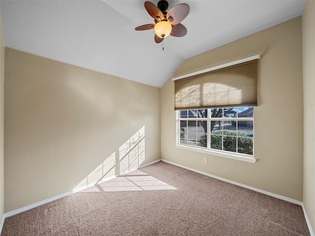 carpeted spare room featuring lofted ceiling and ceiling fan