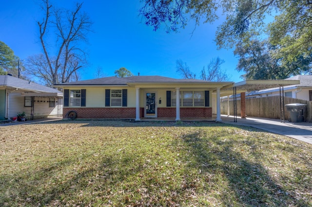 ranch-style home with a front lawn, a carport, and covered porch