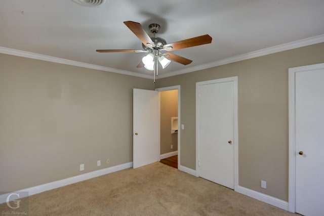 unfurnished bedroom featuring ceiling fan, ornamental molding, and light carpet