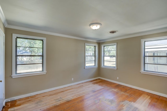 unfurnished room with ornamental molding and light hardwood / wood-style floors