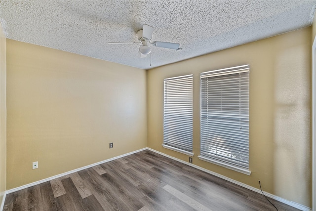 empty room with hardwood / wood-style flooring, ceiling fan, and a textured ceiling