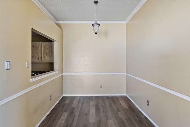 unfurnished dining area with built in shelves, ornamental molding, dark hardwood / wood-style floors, and a textured ceiling