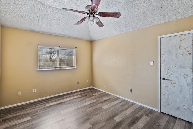 unfurnished room with hardwood / wood-style flooring, ceiling fan, lofted ceiling, and a textured ceiling