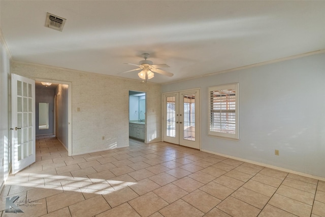 tiled spare room featuring crown molding, ceiling fan, and french doors