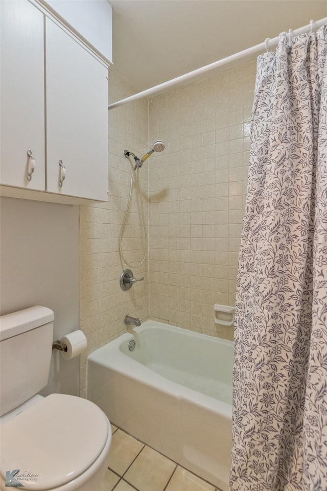 bathroom with tile patterned flooring, shower / bath combination with curtain, and toilet