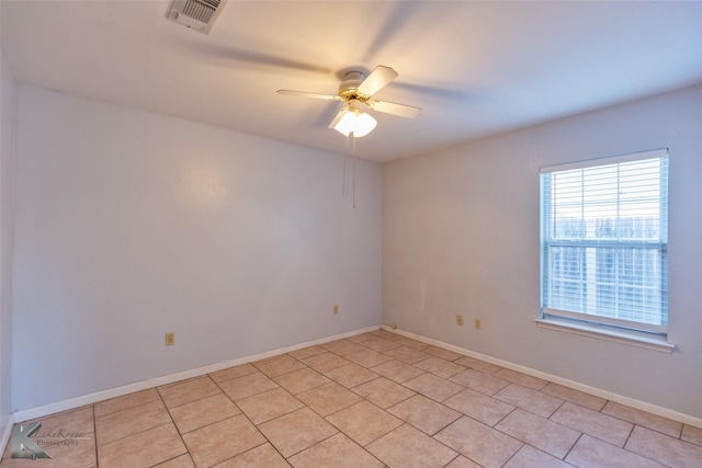 tiled spare room featuring ceiling fan