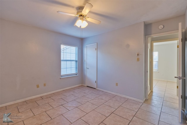 unfurnished room featuring light tile patterned floors and ceiling fan