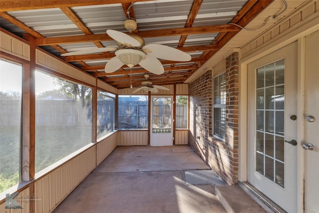 unfurnished sunroom with ceiling fan