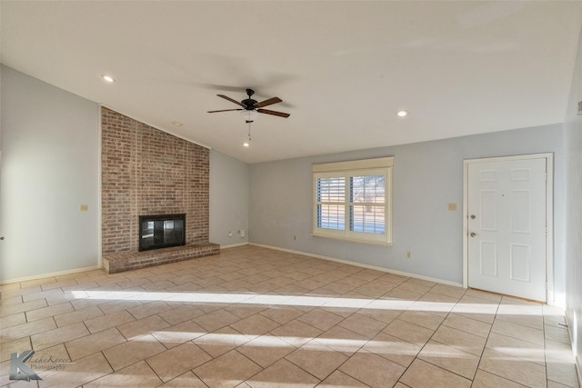 unfurnished living room featuring a brick fireplace, light tile patterned floors, vaulted ceiling, and ceiling fan