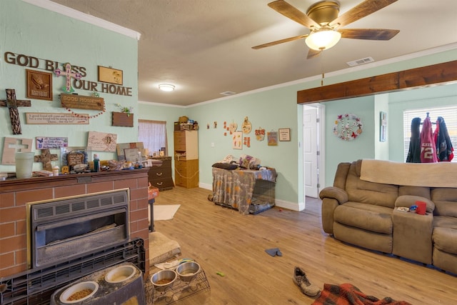 living room featuring ornamental molding, heating unit, ceiling fan, and light hardwood / wood-style floors