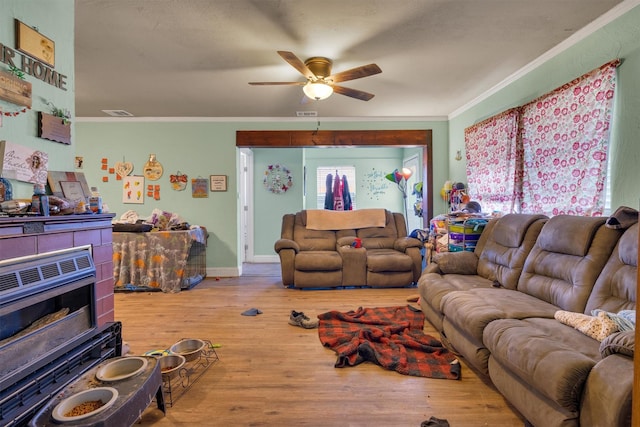 living room featuring crown molding, hardwood / wood-style floors, and ceiling fan