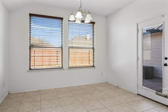 interior space with light tile patterned floors, baseboards, lofted ceiling, and a notable chandelier