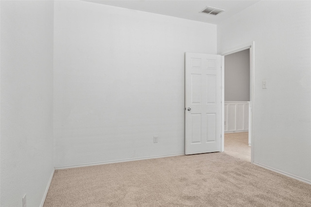 unfurnished room with light colored carpet