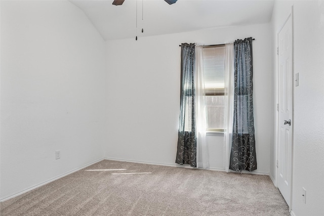 unfurnished room with baseboards, carpet, ceiling fan, and vaulted ceiling