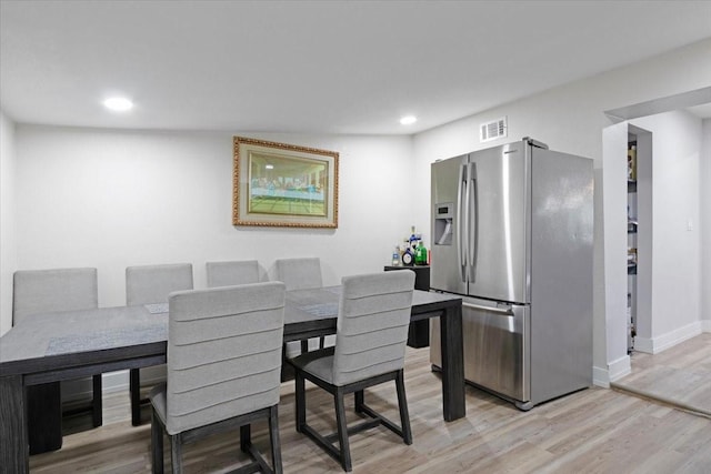 dining space with light hardwood / wood-style flooring