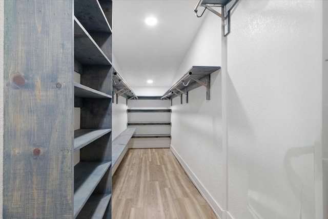 spacious closet with hardwood / wood-style floors