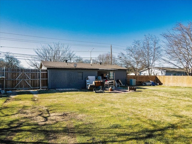 rear view of property featuring a lawn and a patio