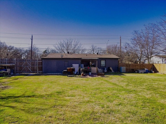 rear view of house with a lawn