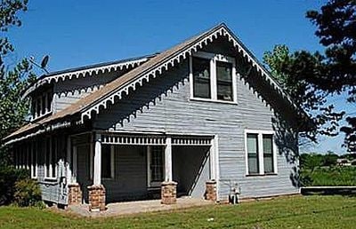 rear view of property featuring a yard